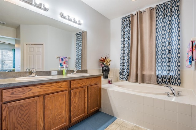 bathroom featuring vanity, tile patterned floors, and a relaxing tiled tub