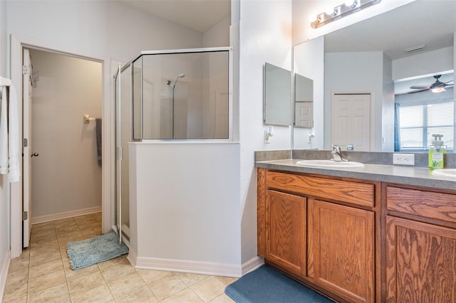 bathroom with ceiling fan, tile patterned flooring, an enclosed shower, and vanity