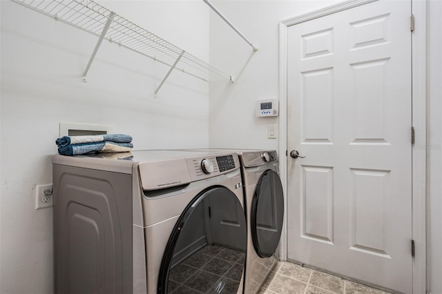 clothes washing area with washing machine and dryer