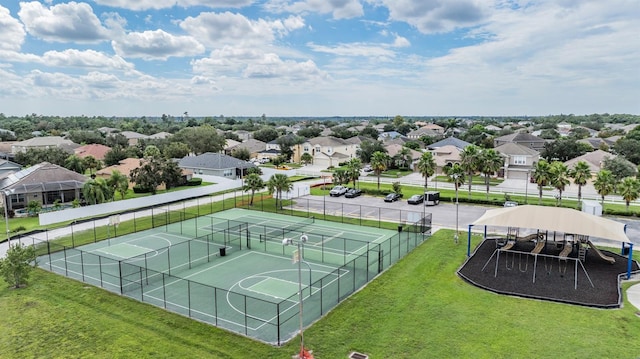 view of sport court with basketball hoop and a yard