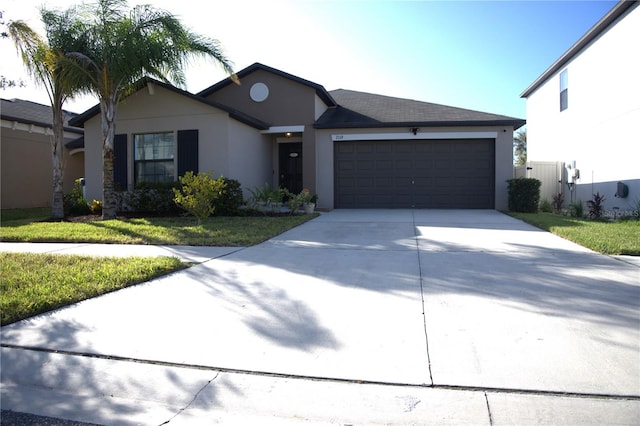 view of front of property with a garage and a front lawn