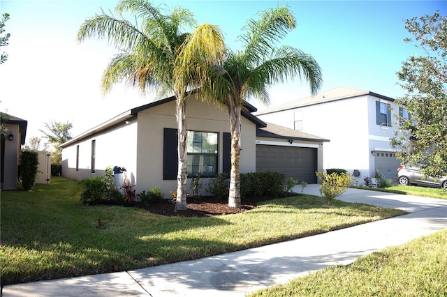 view of front of house with a garage and a front lawn