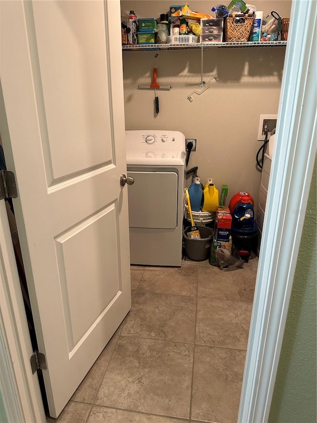 clothes washing area with light tile patterned flooring and washer / dryer