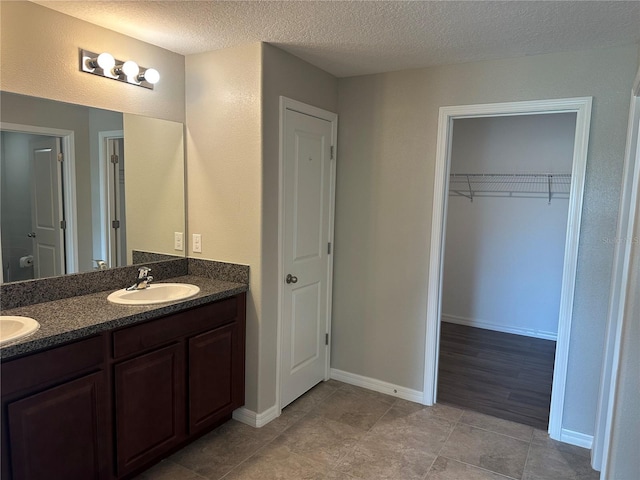 bathroom featuring vanity, a textured ceiling, and wood-type flooring