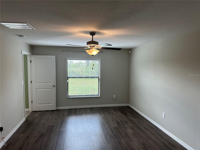 empty room with dark wood-type flooring, ceiling fan, and a textured ceiling