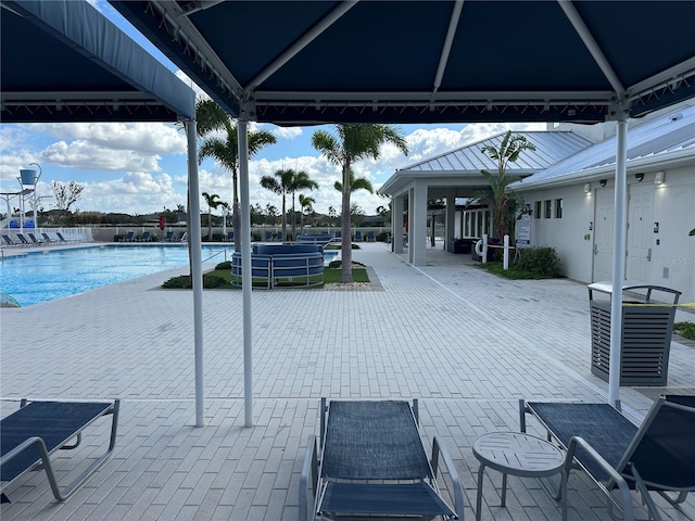 exterior space with a community pool and a gazebo