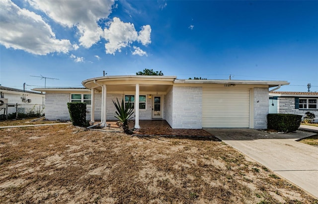 ranch-style home with a garage and covered porch