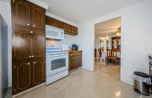 kitchen featuring dark brown cabinetry, white appliances, and ceiling fan