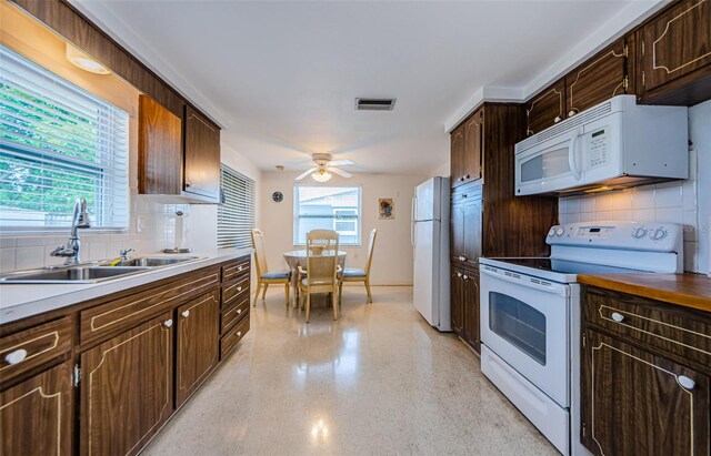 kitchen with white appliances, sink, plenty of natural light, and tasteful backsplash