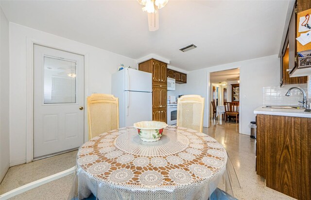 dining room featuring ceiling fan and sink