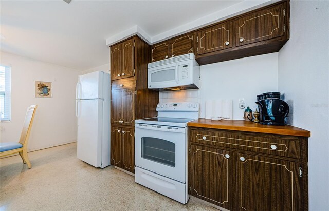 kitchen with decorative backsplash, white appliances, and dark brown cabinets