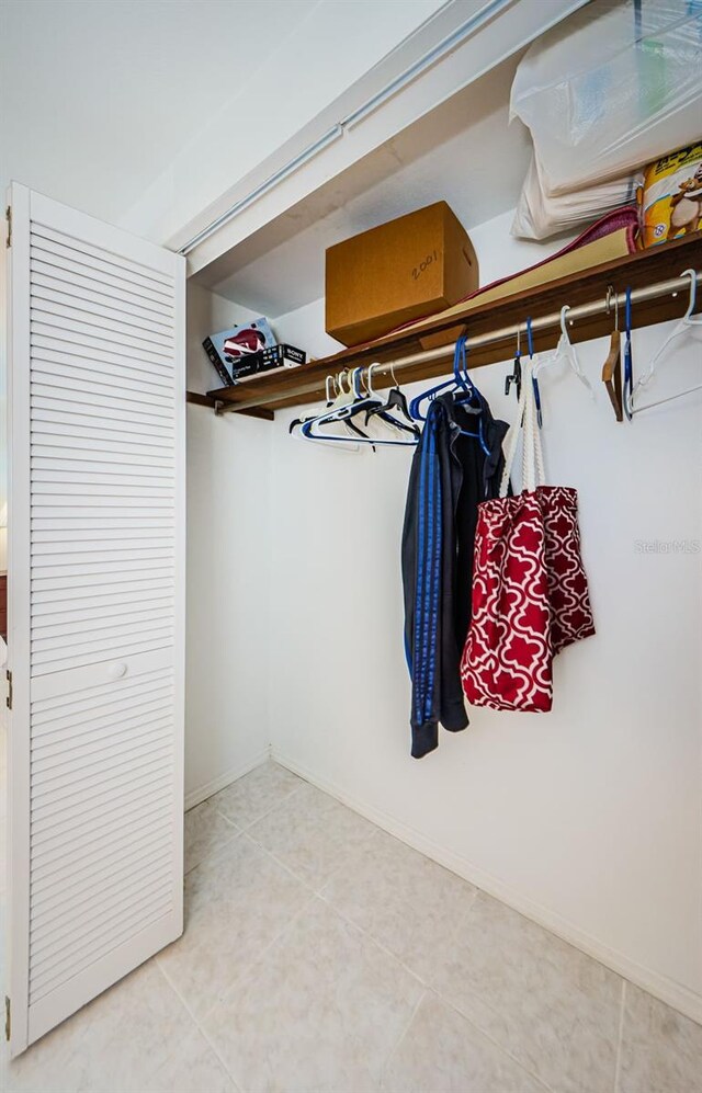 walk in closet with tile patterned floors