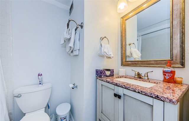 bathroom featuring walk in shower, vanity, and toilet