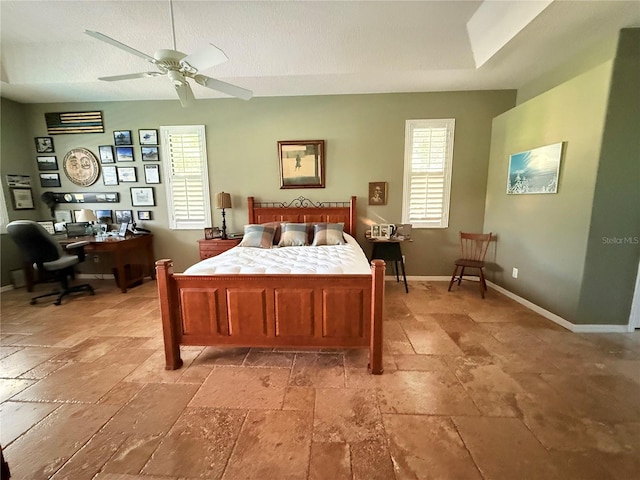 bedroom featuring ceiling fan and a textured ceiling