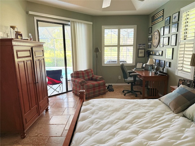 bedroom with access to outside and multiple windows