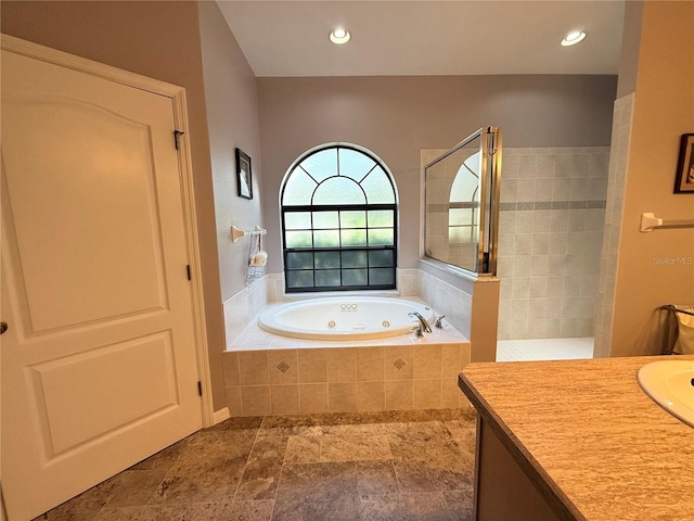 bathroom featuring independent shower and bath and vanity