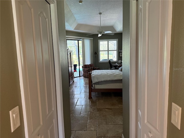 bedroom with a textured ceiling and ceiling fan