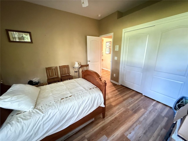 bedroom with wood-type flooring, a closet, and ceiling fan