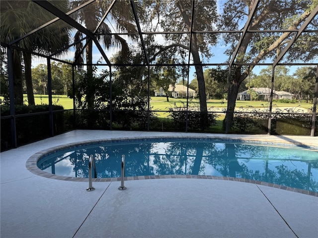 view of swimming pool with a patio and a lanai