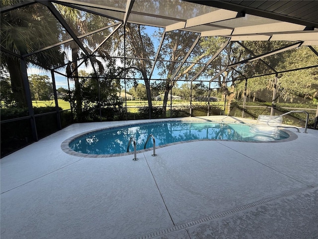 view of pool featuring glass enclosure and a patio