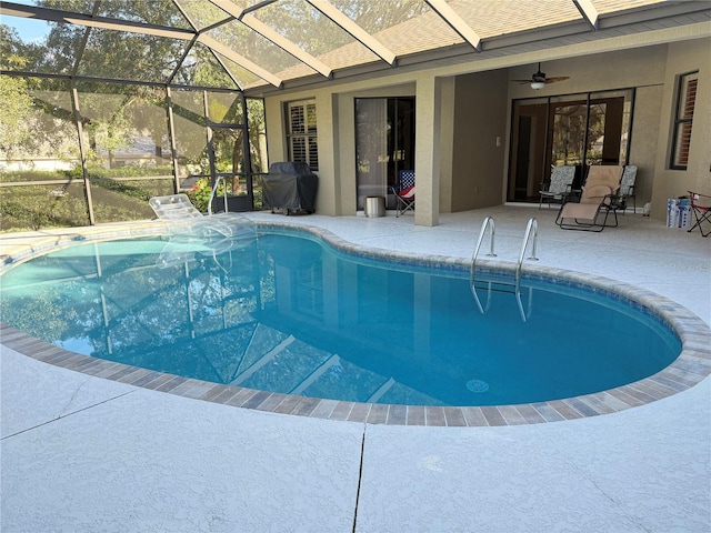 view of swimming pool with grilling area, a lanai, ceiling fan, and a patio area