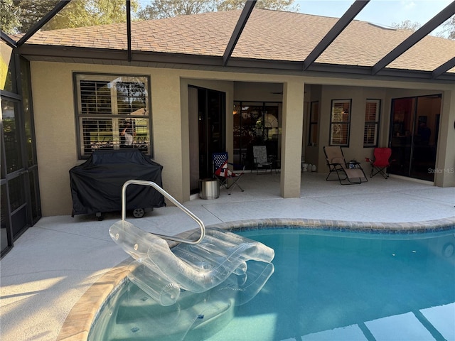 view of pool featuring a lanai, a patio, and grilling area