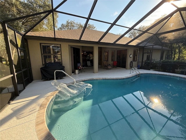 view of swimming pool featuring area for grilling, a lanai, and a patio area