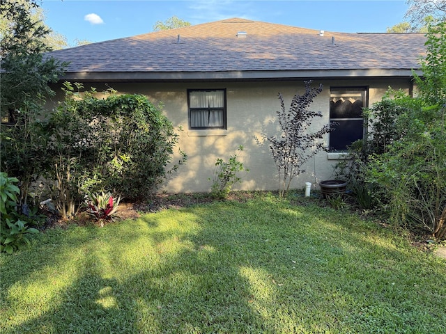 view of side of home with a yard