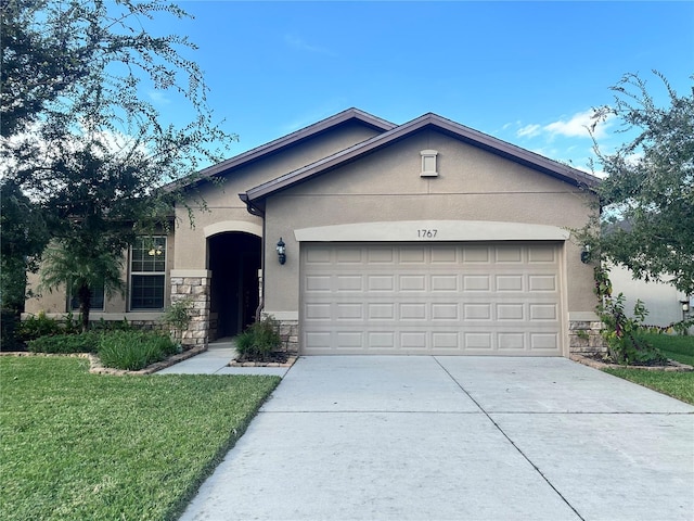 single story home featuring a front lawn and a garage