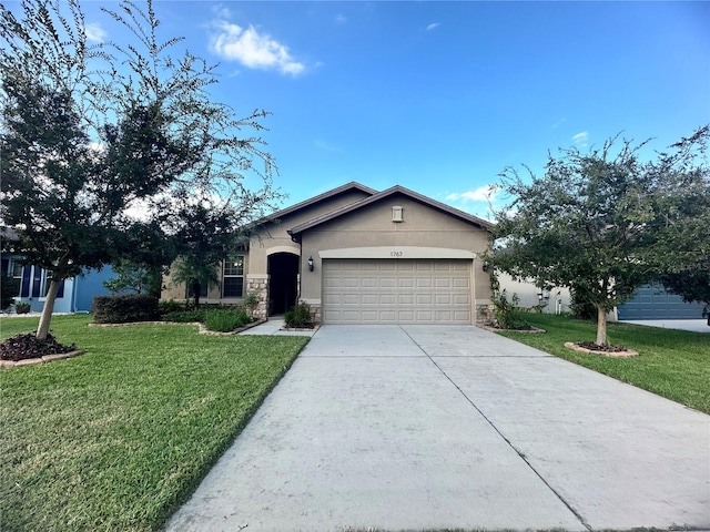 single story home with a front yard and a garage