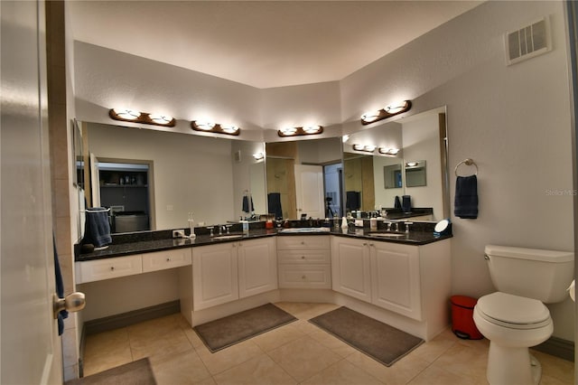 bathroom with vanity, toilet, and tile patterned floors