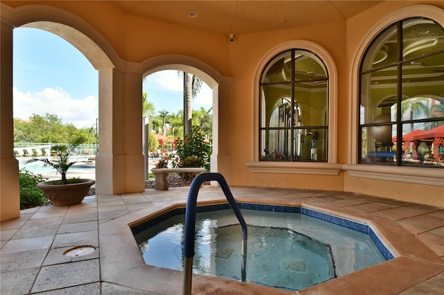 view of pool with an in ground hot tub and a patio area