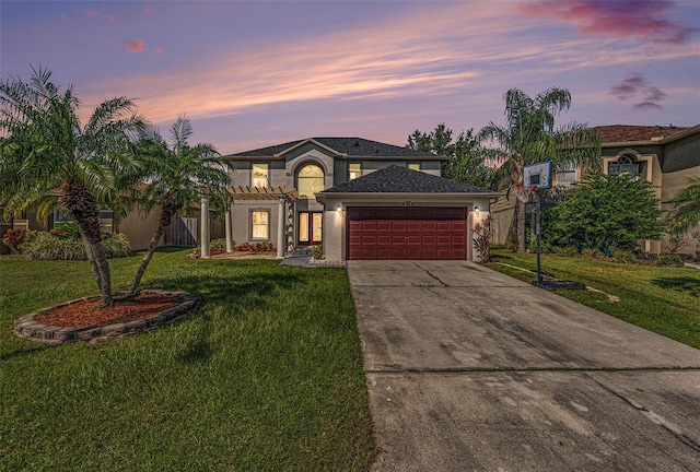 view of front of home featuring a garage and a yard