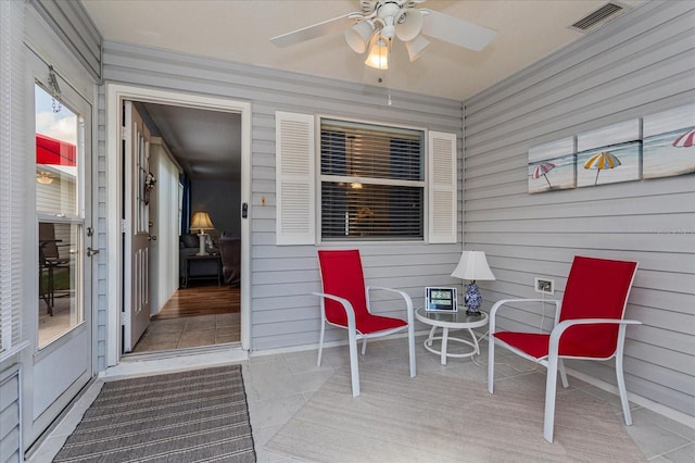 sunroom / solarium featuring ceiling fan