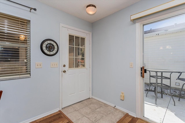 doorway featuring a textured ceiling