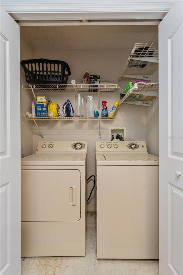 washroom with washer and dryer