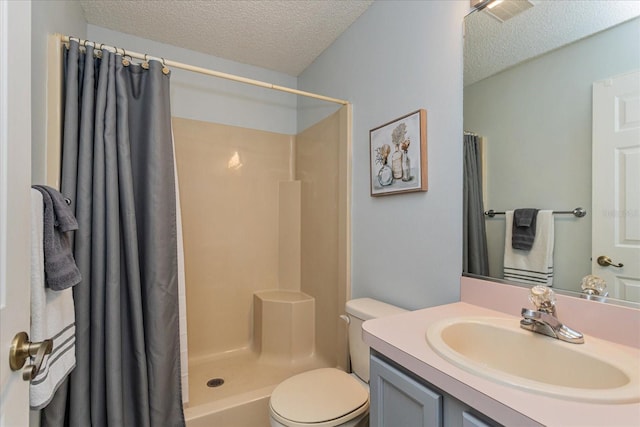 bathroom with a textured ceiling, toilet, vanity, and walk in shower