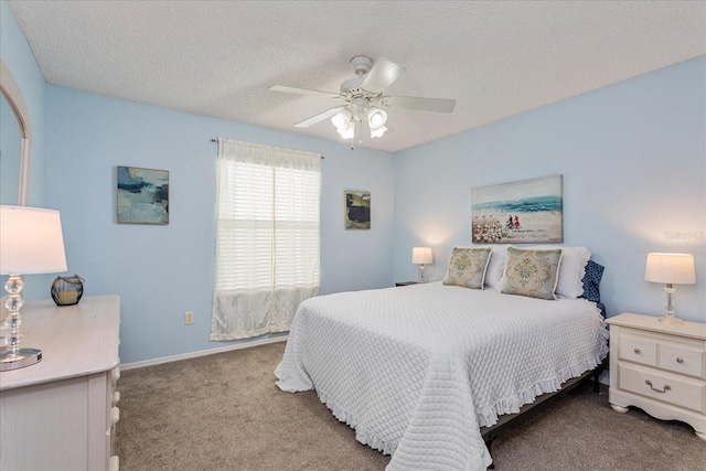 carpeted bedroom with ceiling fan and a textured ceiling