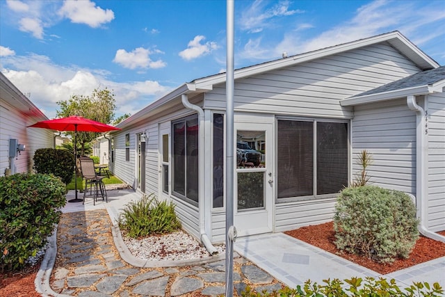 view of side of property with a patio area