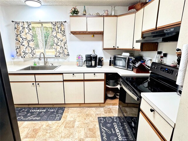 kitchen with range with electric stovetop, white cabinetry, sink, and a textured ceiling