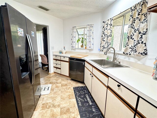 kitchen with white cabinets, a textured ceiling, sink, dishwasher, and stainless steel fridge with ice dispenser