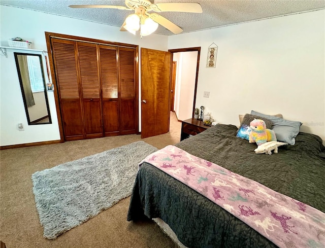 carpeted bedroom with a textured ceiling, a closet, and ceiling fan