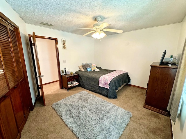 bedroom with light carpet, a closet, and ceiling fan