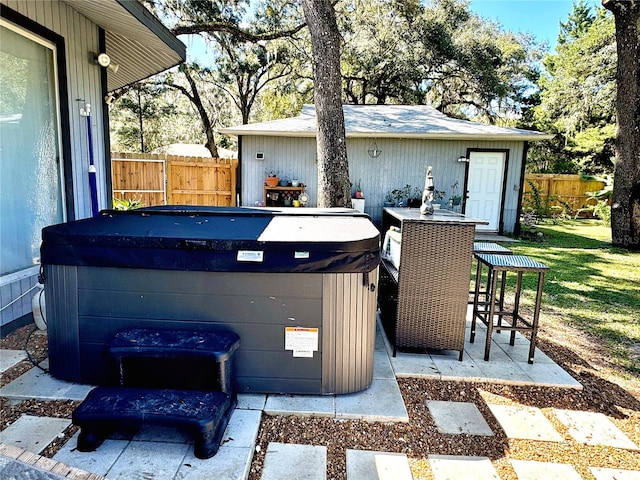 view of patio with a bar and a hot tub