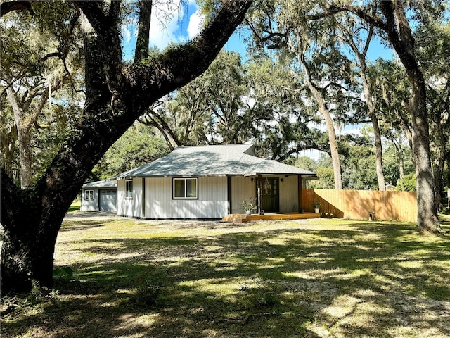 rear view of house with a yard