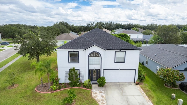 view of front of property with a front yard and a garage