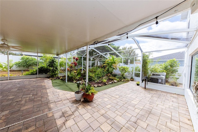 view of patio featuring glass enclosure and ceiling fan