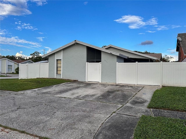 view of property exterior with a patio and a yard