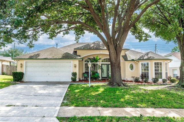 ranch-style home featuring a garage and a front lawn