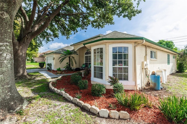 view of side of home featuring a garage